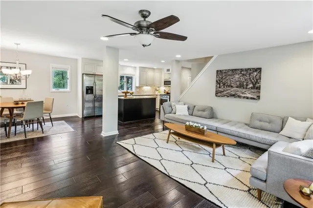 a living room with furniture and wooden floor