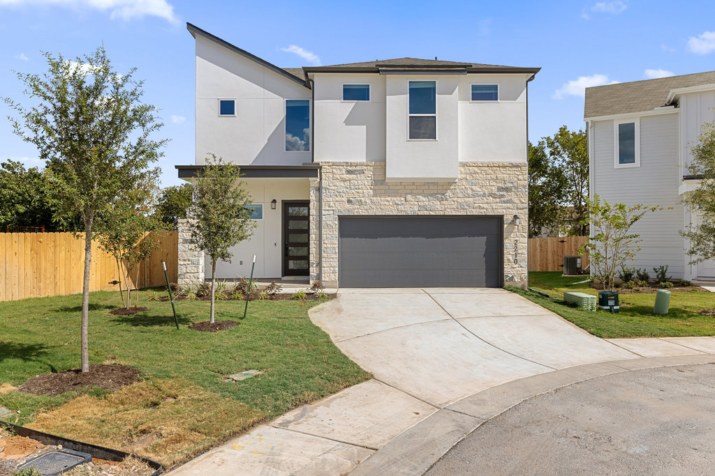 2205 Cento Walk Round Rock, TX 78664 - Photo 1 of 26 Contemporary house featuring stone siding, stucco siding, an attached garage, and concrete driveway
Photos are NOT exact home.