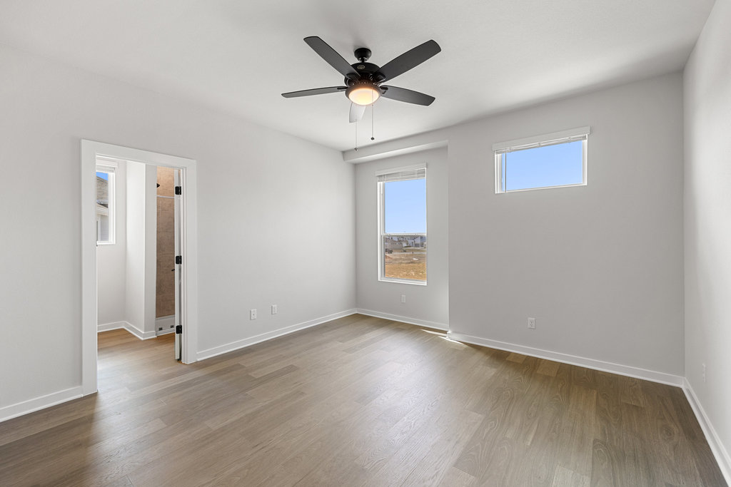 2205 Cento Walk Round Rock, TX 78664 - Photo 14 of 26 Empty room with light wood finished floors and ceiling fan