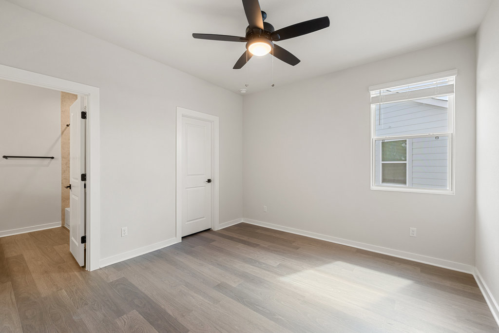 2205 Cento Walk Round Rock, TX 78664 - Photo 16 of 26 Unfurnished bedroom with light wood-style floors and ceiling fan