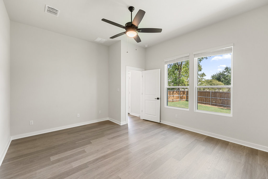 2205 Cento Walk Round Rock, TX 78664 - Photo 8 of 26 Unfurnished room with light wood-style floors and ceiling fan