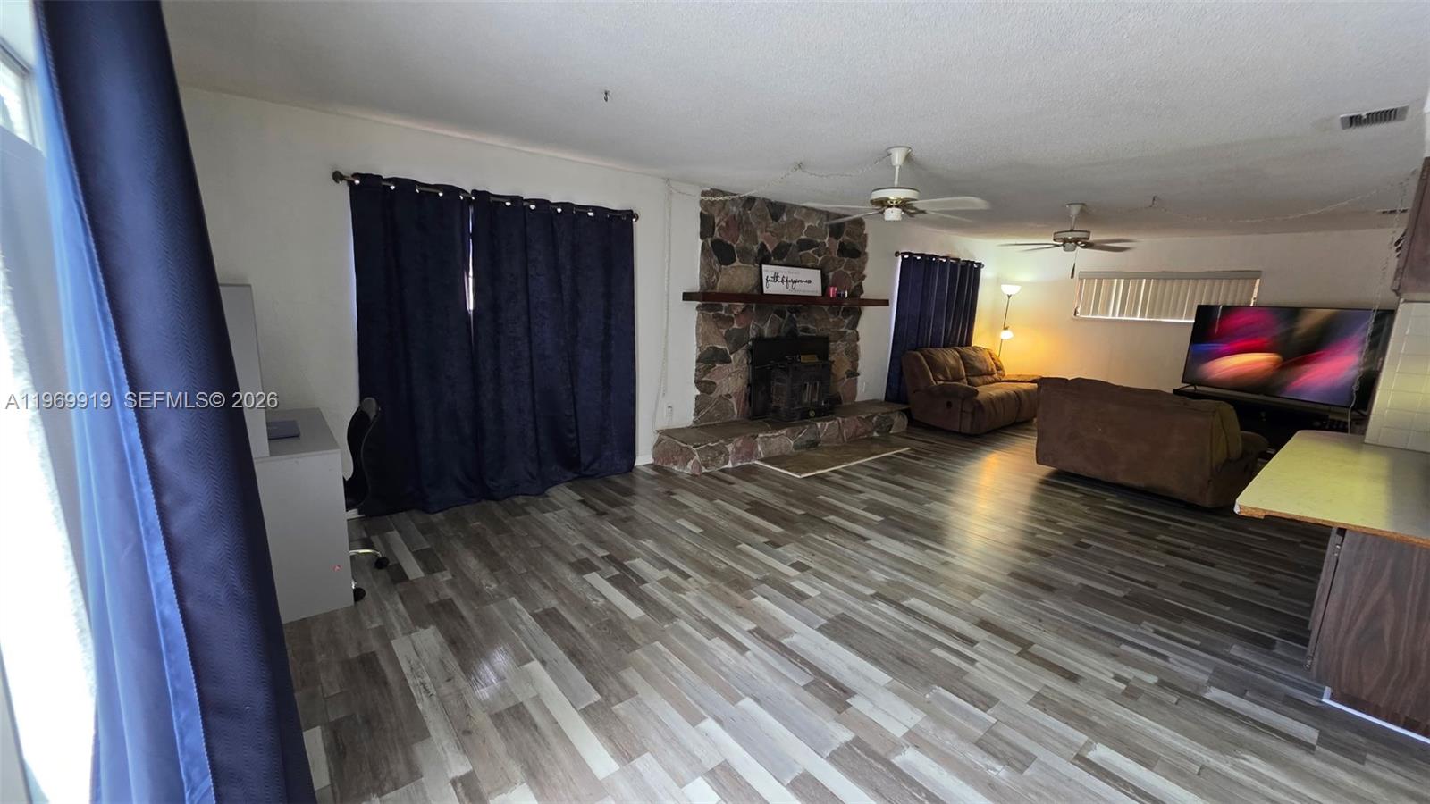 18227 Branch Road Hudson, FL 34667 - Photo 2 of 17 a living room with furniture and a wooden floor