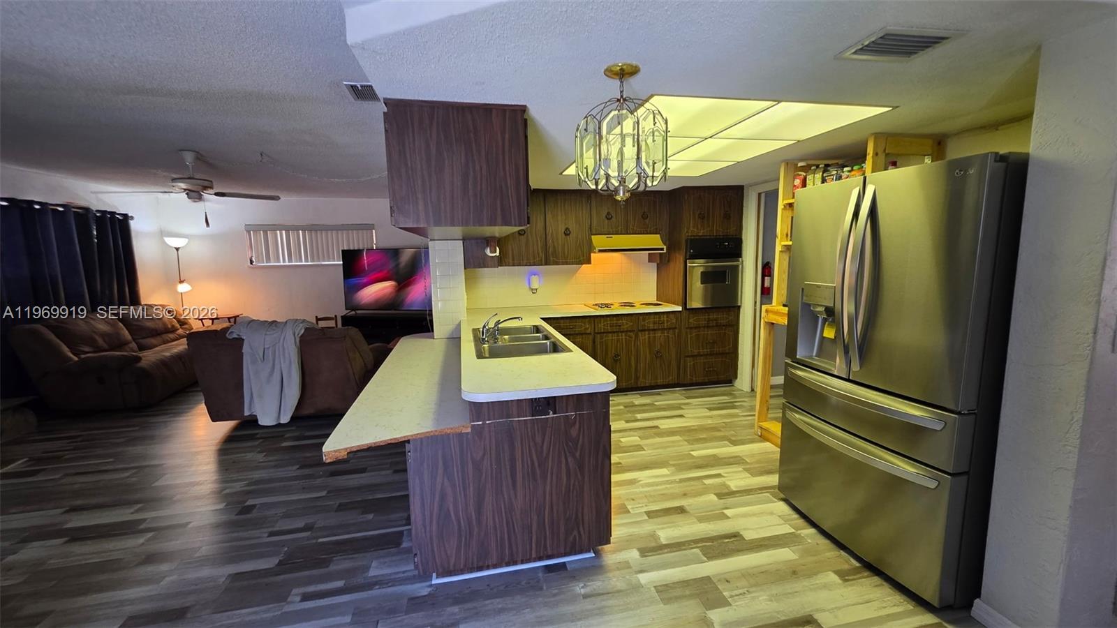 18227 Branch Road Hudson, FL 34667 - Photo 7 of 17 a kitchen with kitchen island wooden cabinets stainless steel appliances and a counter top space