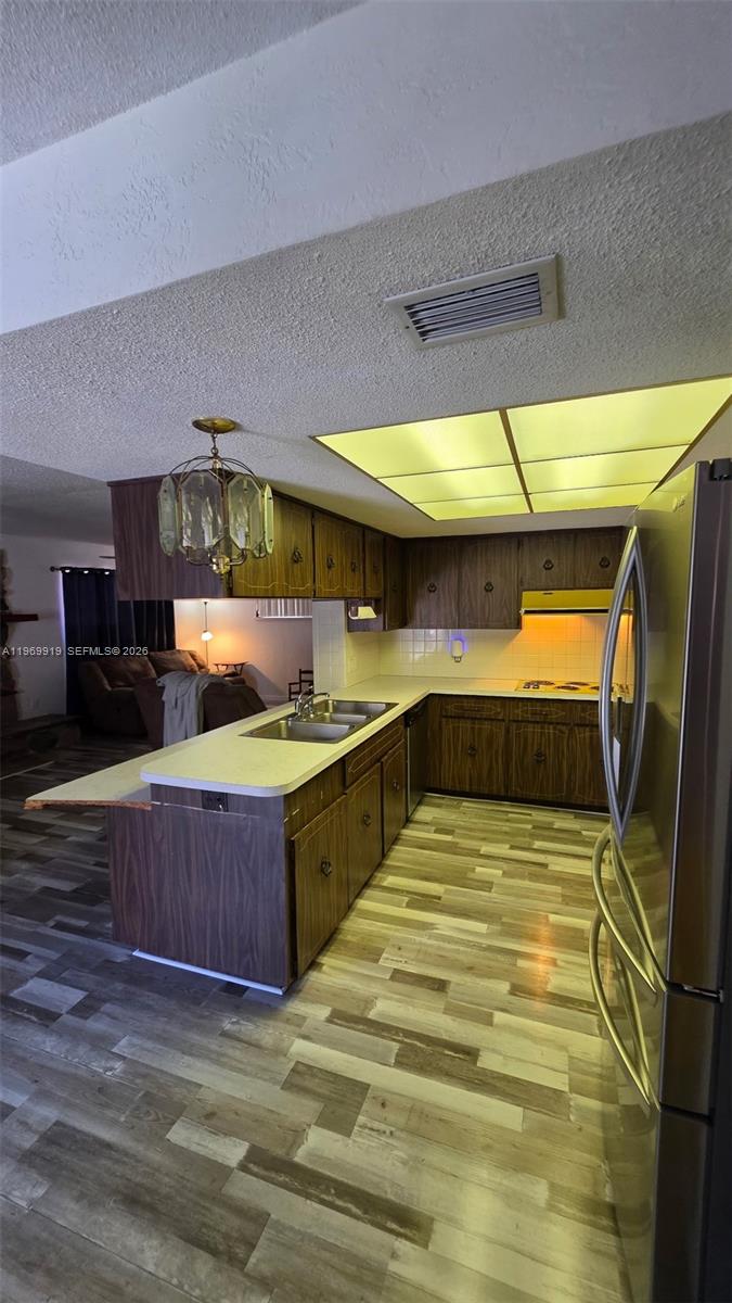 18227 Branch Road Hudson, FL 34667 - Photo 8 of 17 a kitchen with stainless steel appliances wooden cabinets a sink and dishwasher