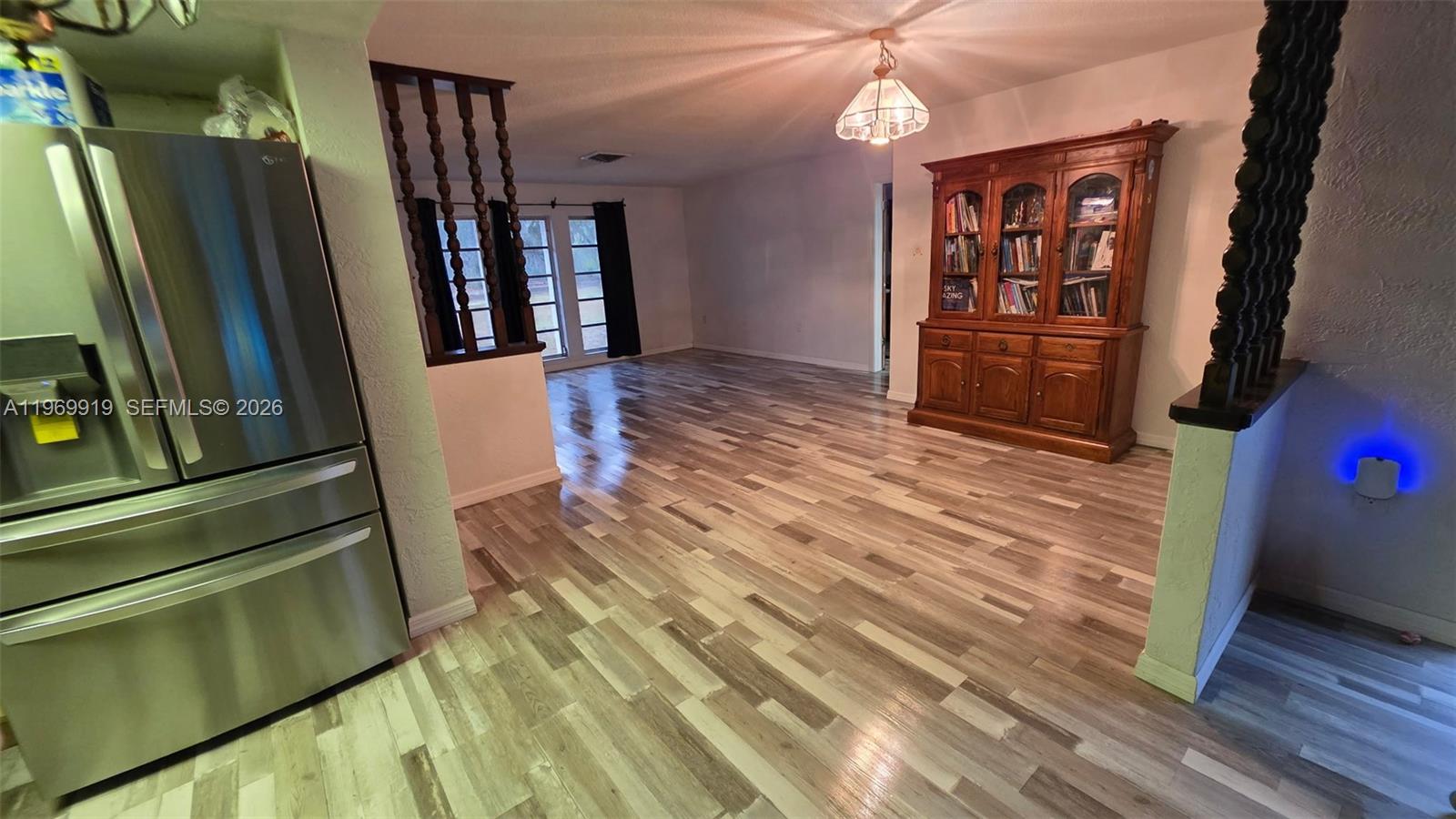 18227 Branch Road Hudson, FL 34667 - Photo 9 of 17 a view of a hallway with wooden floor and staircase