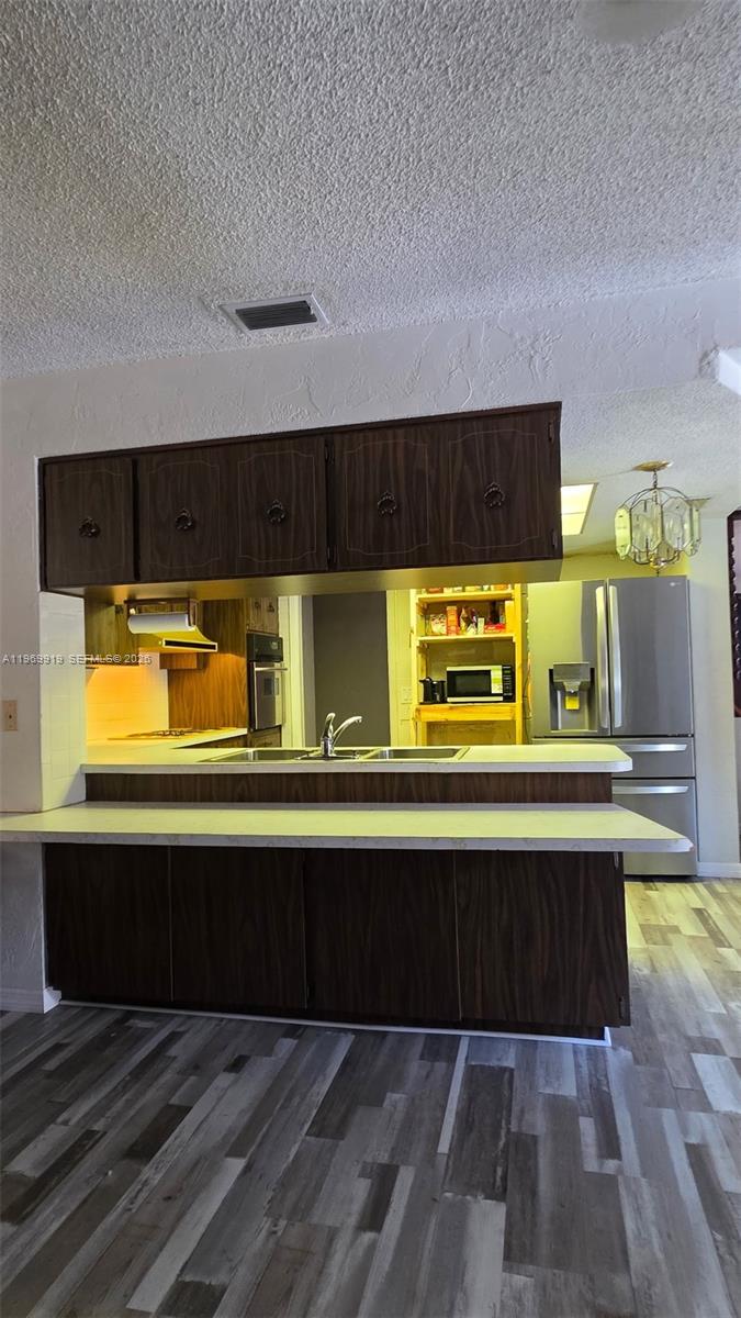 18227 Branch Road Hudson, FL 34667 - Photo 10 of 17 a kitchen with a sink and a refrigerator