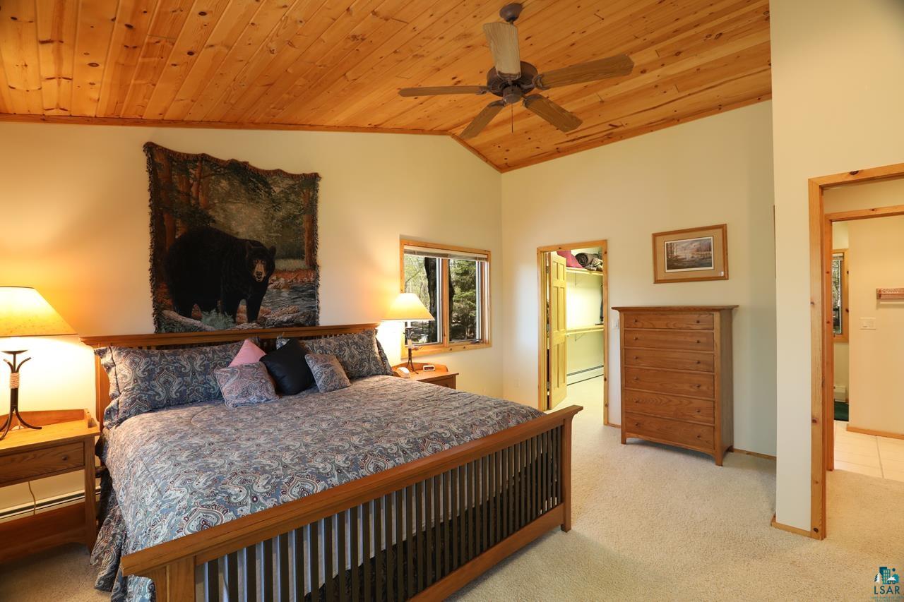 1880 Everett Bay Road Tower, MN 55790 - Photo 9 of 50 Carpeted bedroom with vaulted ceiling, wooden ceiling, and ceiling fan