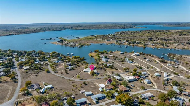 an aerial view of a city with ocean view in back