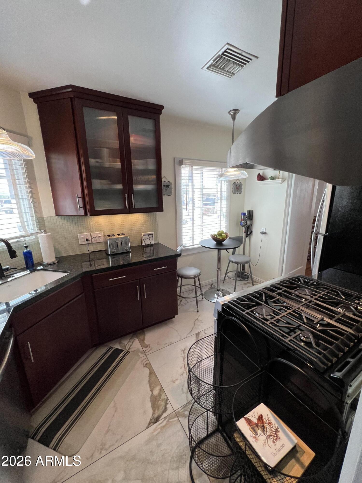 1326 East Coronado Road Phoenix, AZ 85006 - Photo 10 of 36 a kitchen with a stove and a refrigerator