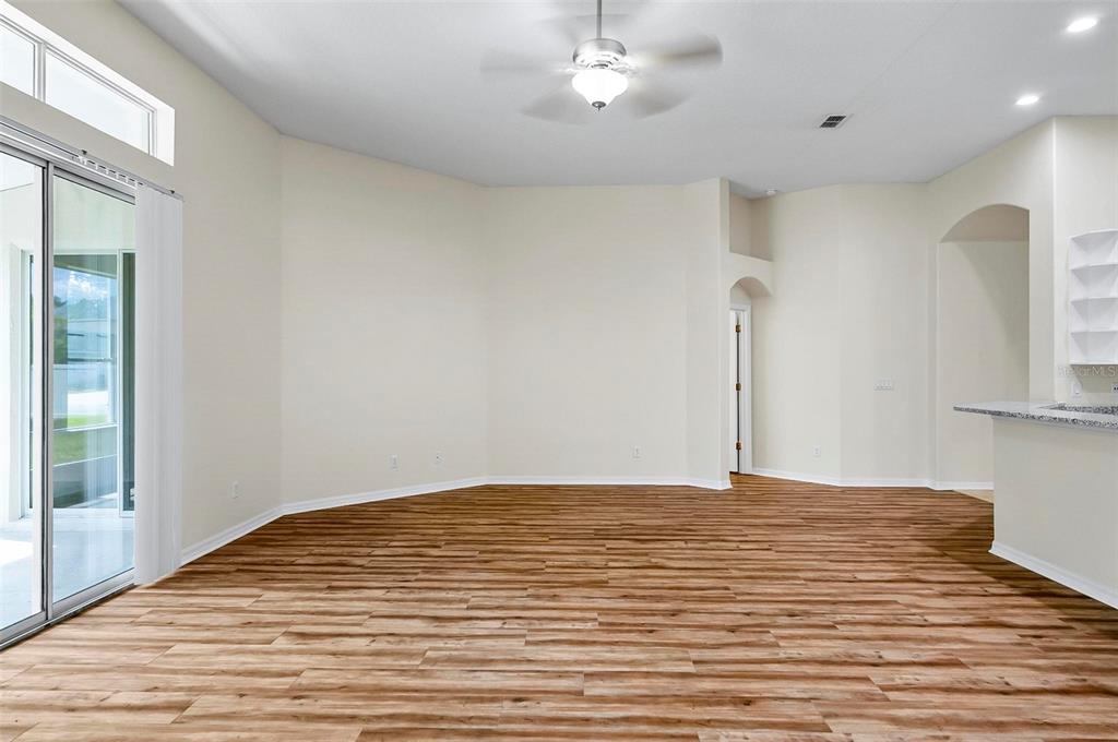 91 Sea Trail Palm Coast, FL 32164 - Photo 19 of 78 a view of a room with wooden floor and a ceiling fan
