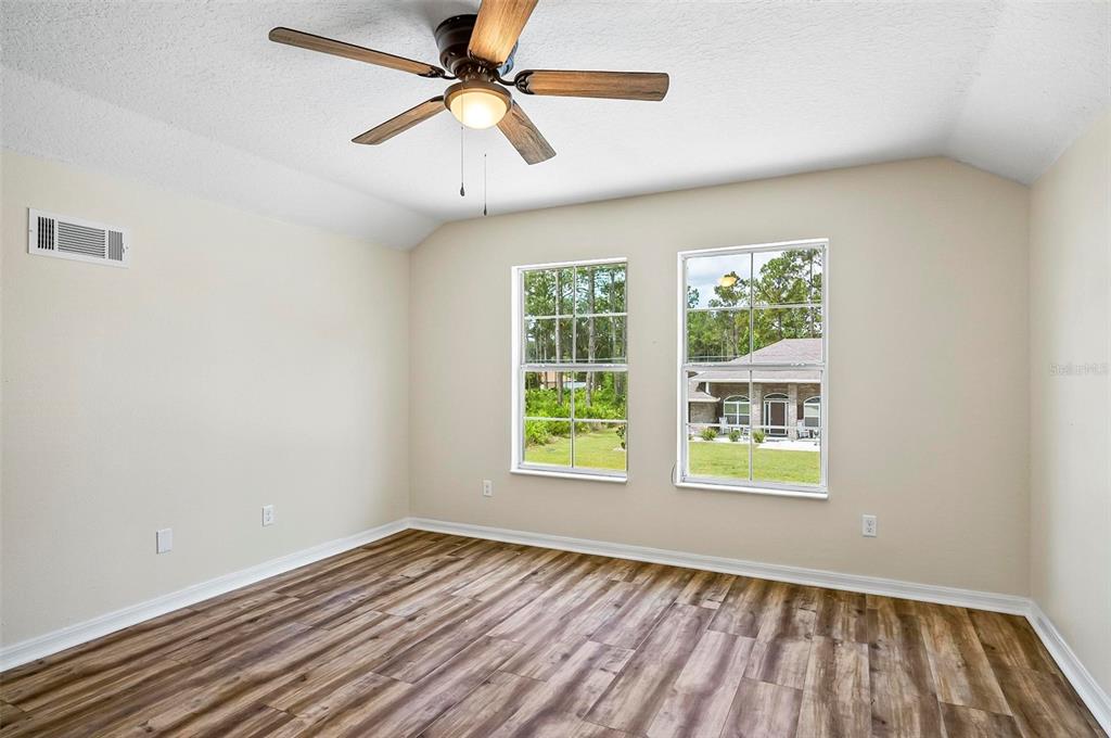 91 Sea Trail Palm Coast, FL 32164 - Photo 22 of 78 wooden floor in an empty room with a window