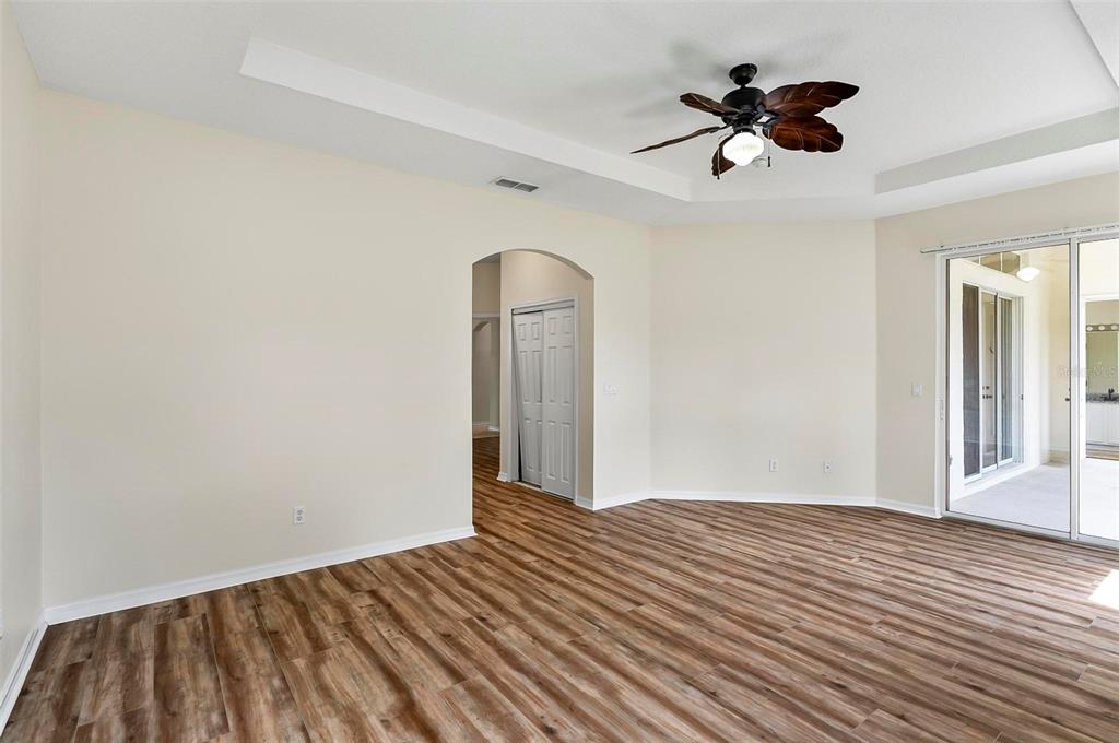 91 Sea Trail Palm Coast, FL 32164 - Photo 23 of 78 a view of a livingroom with wooden floor and a ceiling fan