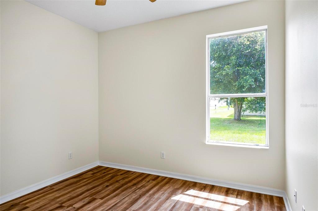 91 Sea Trail Palm Coast, FL 32164 - Photo 25 of 78 a view of an empty room with wooden floor and a window
