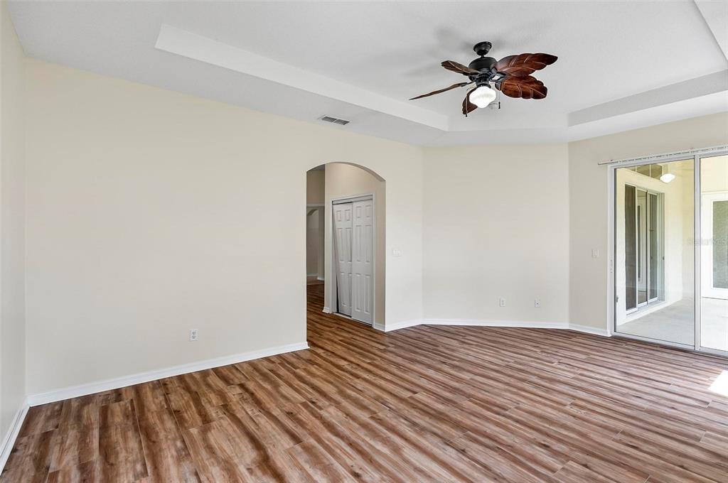 91 Sea Trail Palm Coast, FL 32164 - Photo 26 of 78 a view of a room with wooden floor and ceiling fan