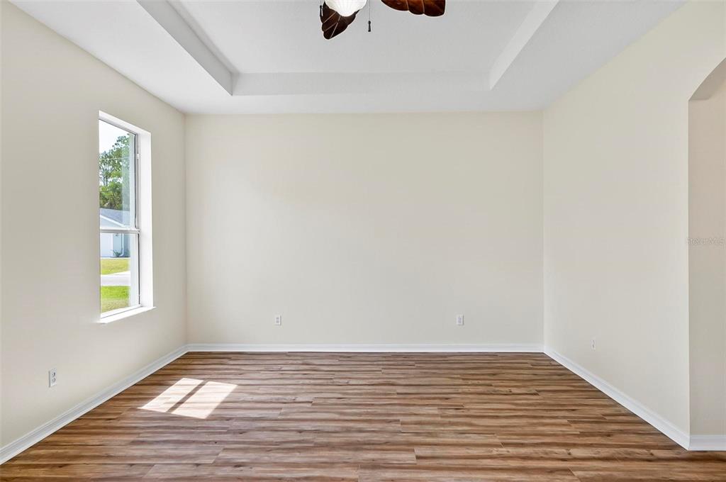 91 Sea Trail Palm Coast, FL 32164 - Photo 28 of 78 a view of an empty room with wooden floor and a window