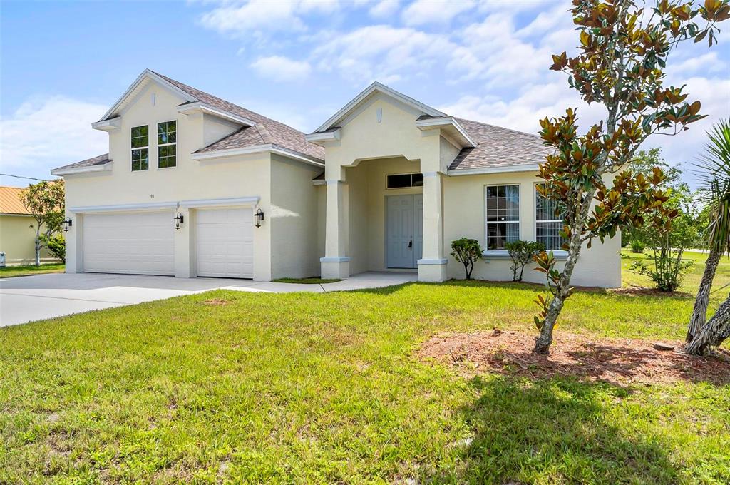 91 Sea Trail Palm Coast, FL 32164 - Photo 3 of 78 a view of a house with backyard and a tree