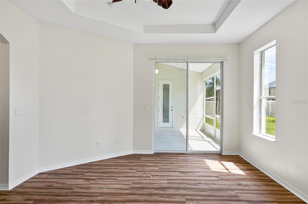 91 Sea Trail Palm Coast, FL 32164 - Photo 34 of 78 a view of an empty room with wooden floor and a window