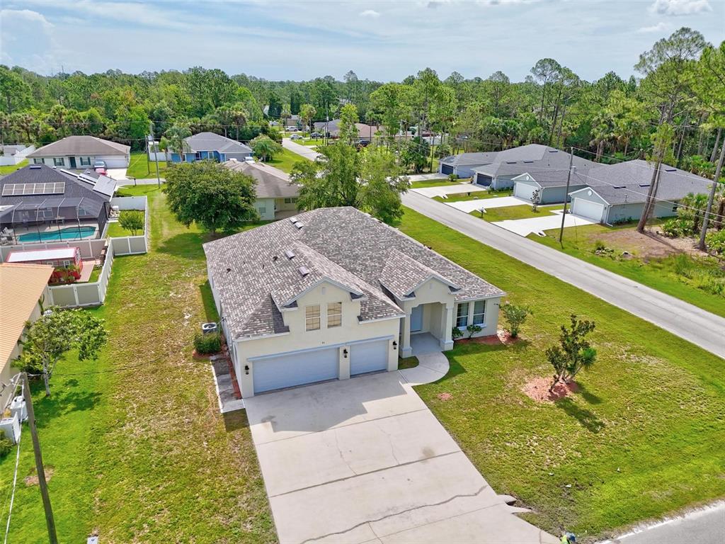 91 Sea Trail Palm Coast, FL 32164 - Photo 4 of 78 a view of a swimming pool with a garden and couches