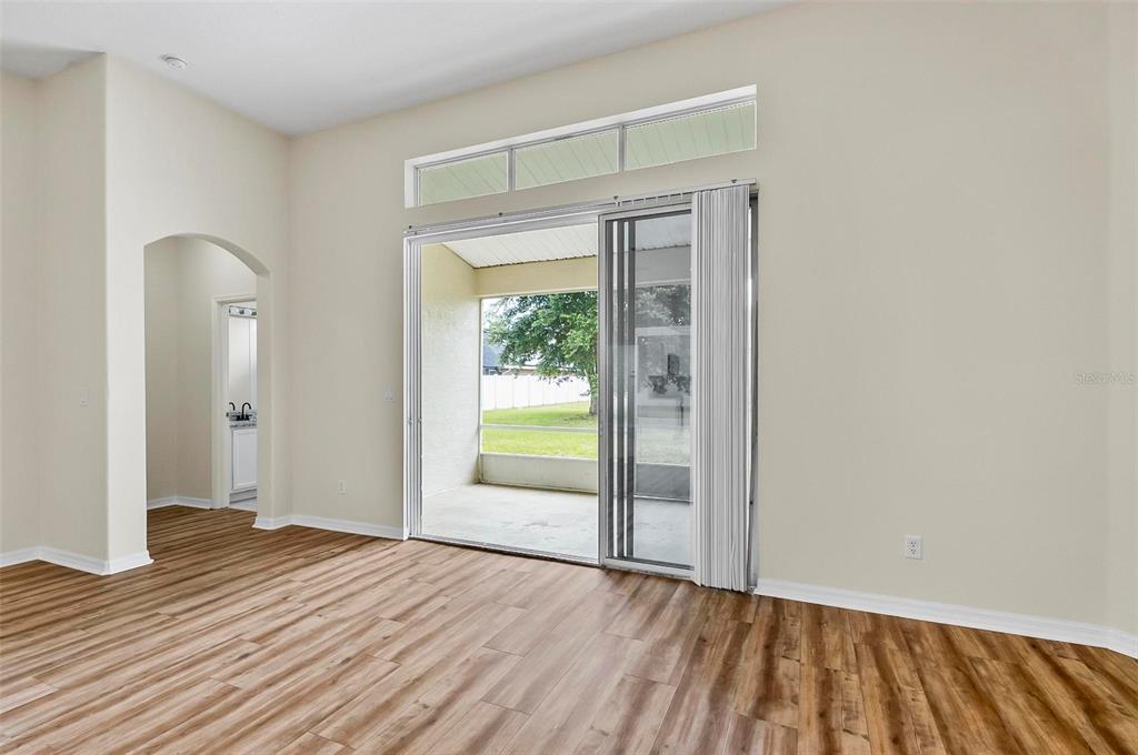 91 Sea Trail Palm Coast, FL 32164 - Photo 41 of 78 a view of an empty room with wooden floor and a window