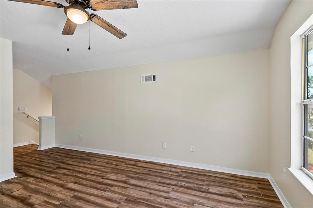 91 Sea Trail Palm Coast, FL 32164 - Photo 45 of 78 a view of a room with wooden floor and ceiling fan