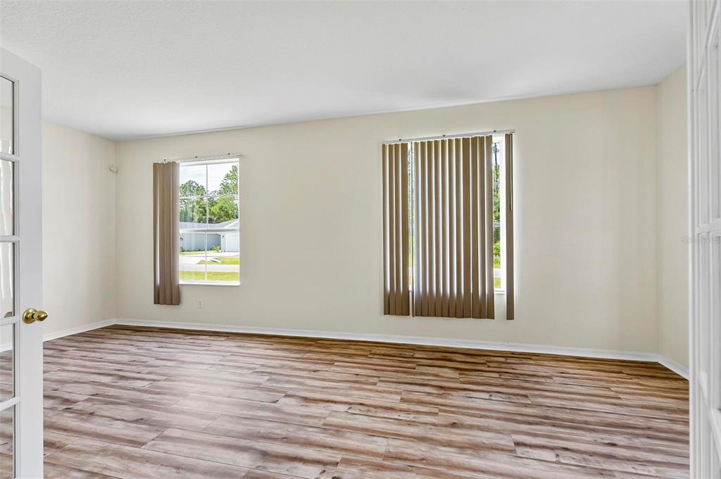 91 Sea Trail Palm Coast, FL 32164 - Photo 47 of 78 a view of an empty room with wooden floor and a window