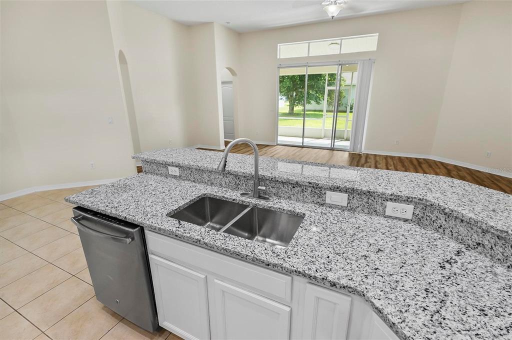 91 Sea Trail Palm Coast, FL 32164 - Photo 52 of 78 a kitchen with granite countertop a sink and a window