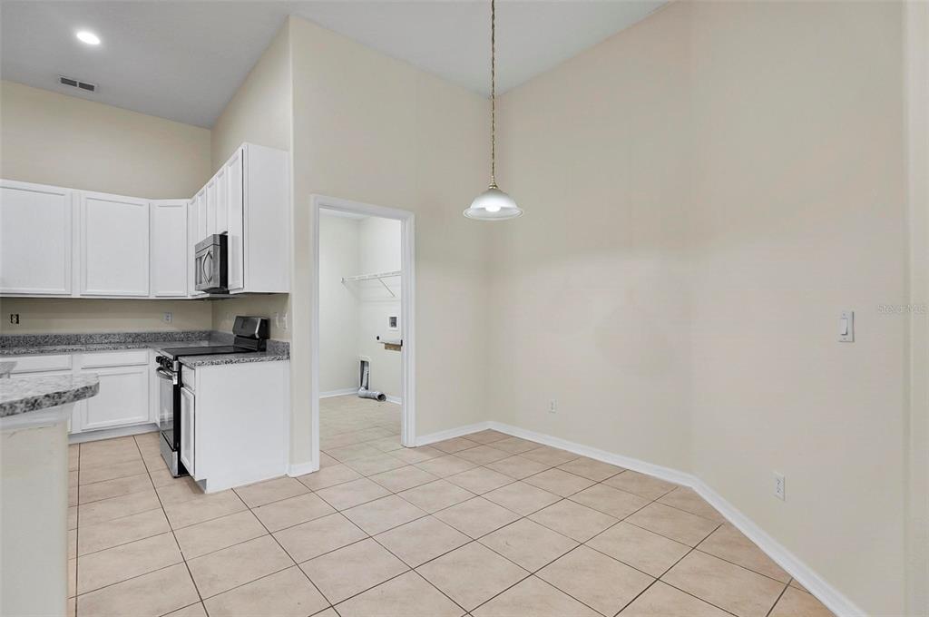 91 Sea Trail Palm Coast, FL 32164 - Photo 55 of 78 a kitchen with white cabinets and white appliances