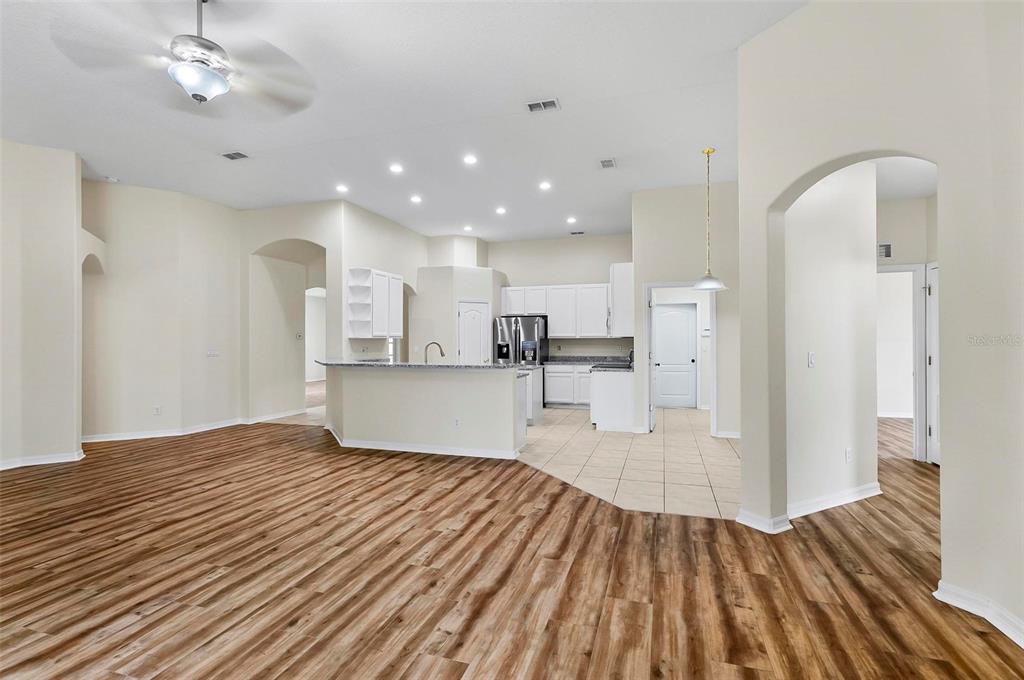 91 Sea Trail Palm Coast, FL 32164 - Photo 57 of 78 a view of kitchen and empty room with wooden floor