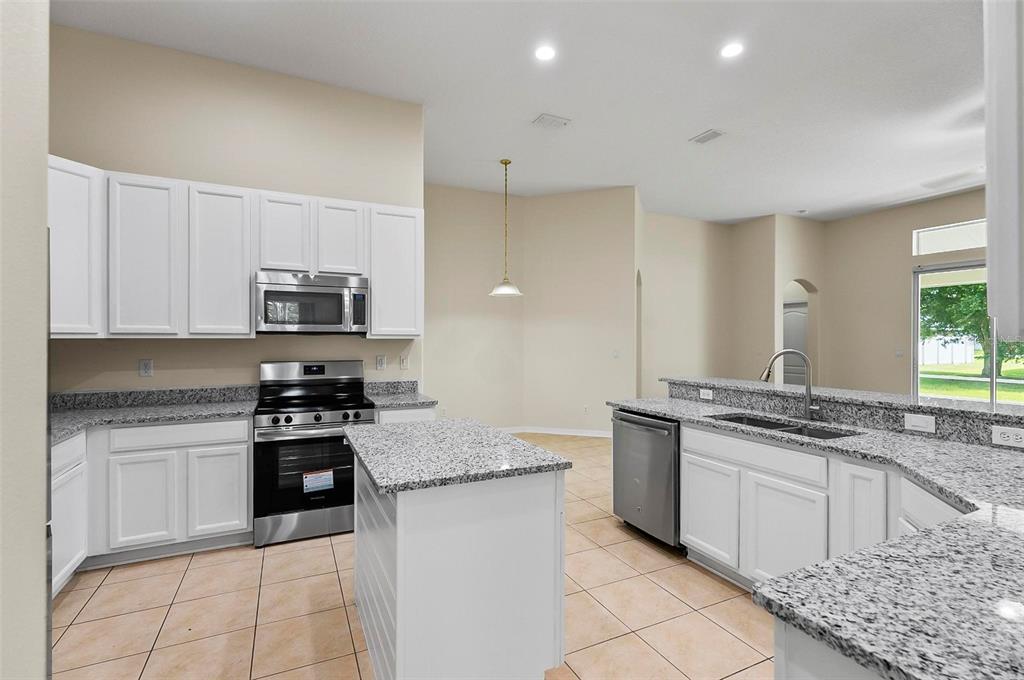 91 Sea Trail Palm Coast, FL 32164 - Photo 58 of 78 a kitchen with stainless steel appliances granite countertop a stove a sink and a granite counter tops