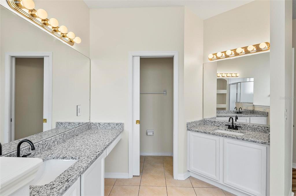91 Sea Trail Palm Coast, FL 32164 - Photo 61 of 78 a bathroom with a granite countertop sink and a mirror