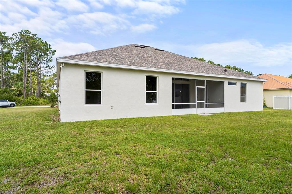 91 Sea Trail Palm Coast, FL 32164 - Photo 7 of 78 a view of a house with backyard porch and garden