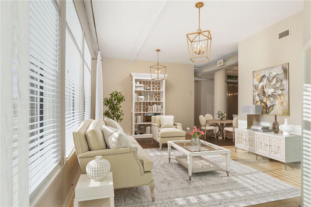 a living room with furniture a chandelier and a window