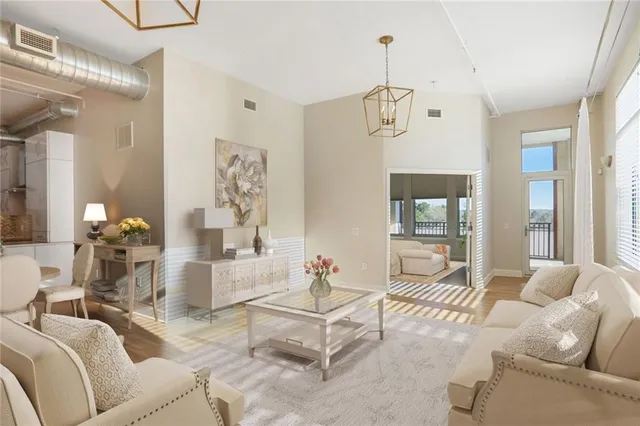 a living room with furniture and a chandelier