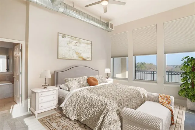 a bedroom with a bed and a large window