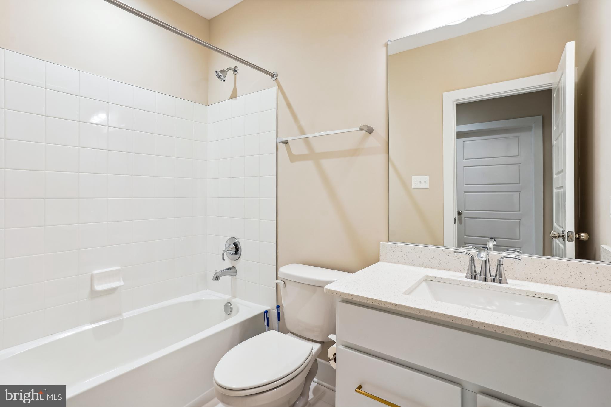 4996 Ilchester Road Ellicott City, MD 21043 - Photo 64 of 74 a bathroom with a sink a toilet and a bathtub