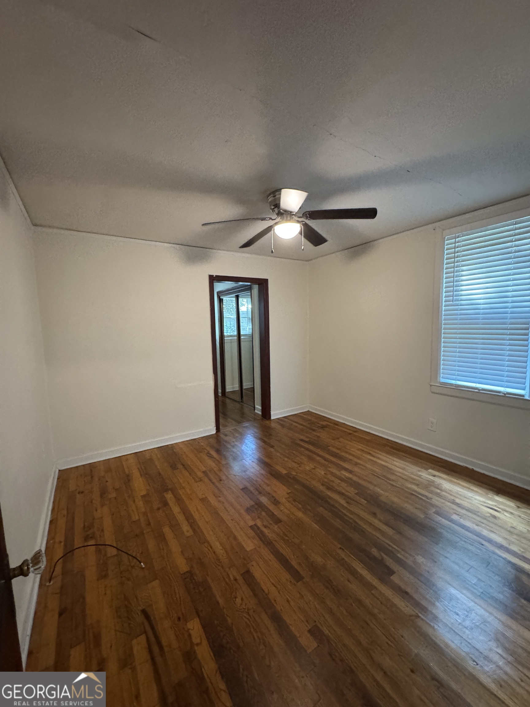 1980 South Lumpkin Street, Unit B Athens, GA 30606 - Photo 11 of 13 a view of an empty room with wooden floor and a window