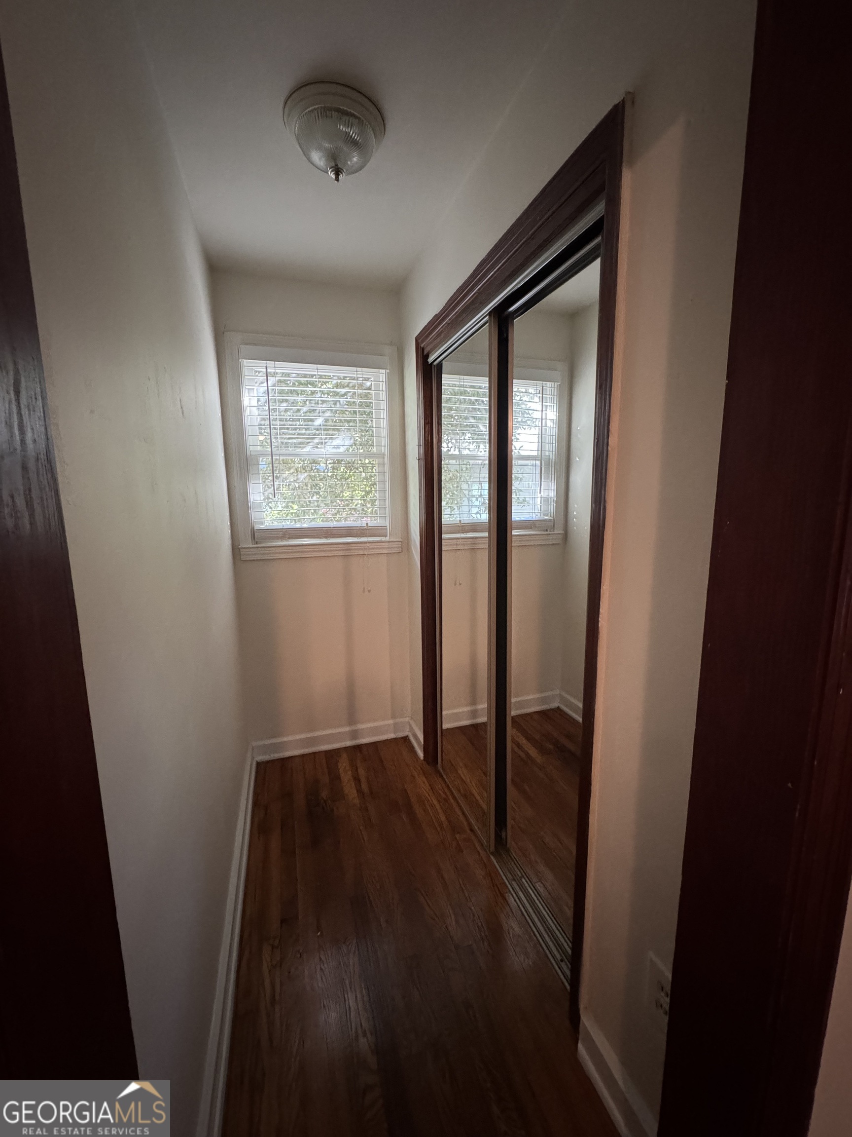 1980 South Lumpkin Street, Unit B Athens, GA 30606 - Photo 12 of 13 an empty room with wooden floor and windows