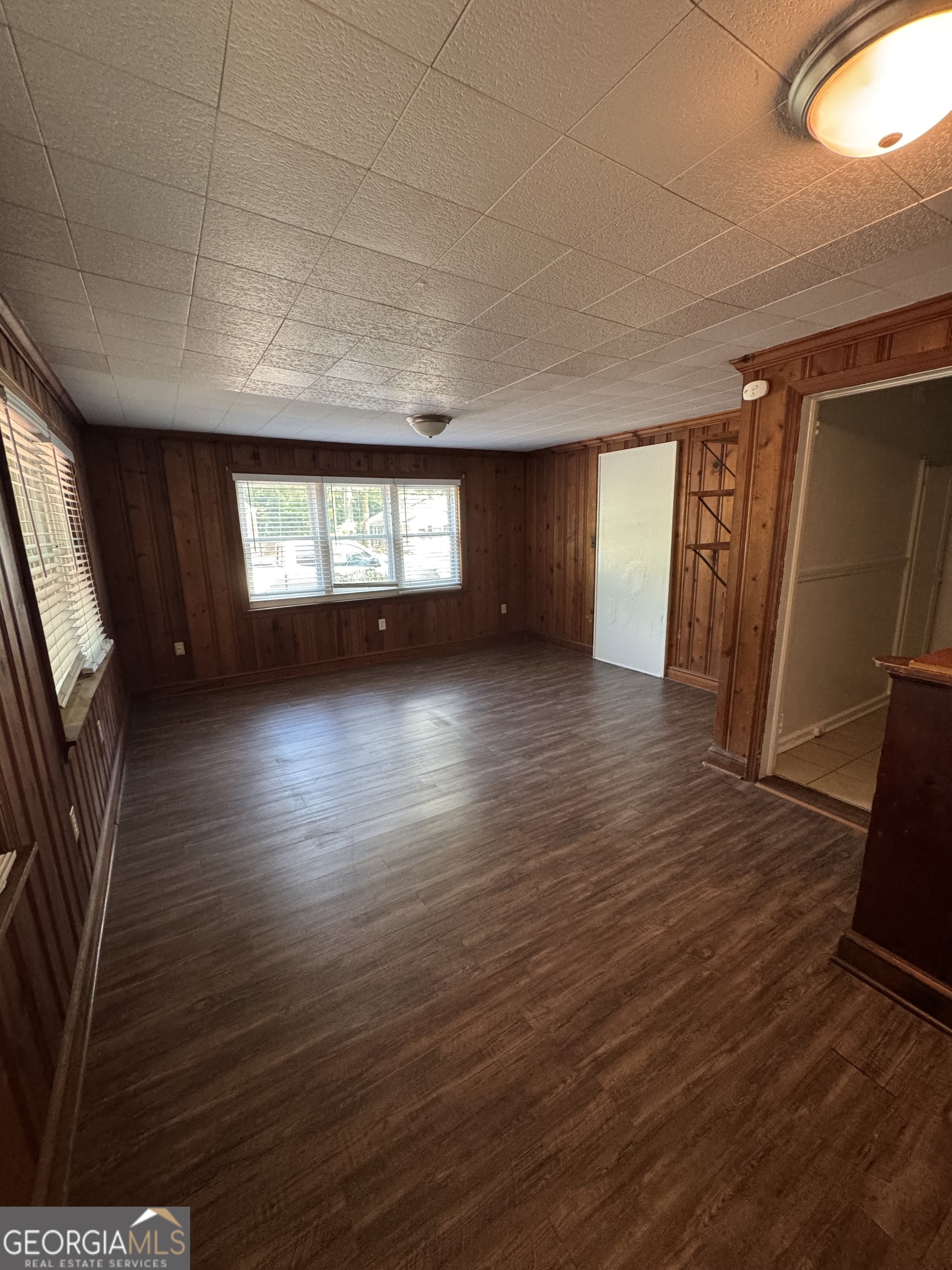 1980 South Lumpkin Street, Unit B Athens, GA 30606 - Photo 4 of 13 an empty room with wooden floor and windows