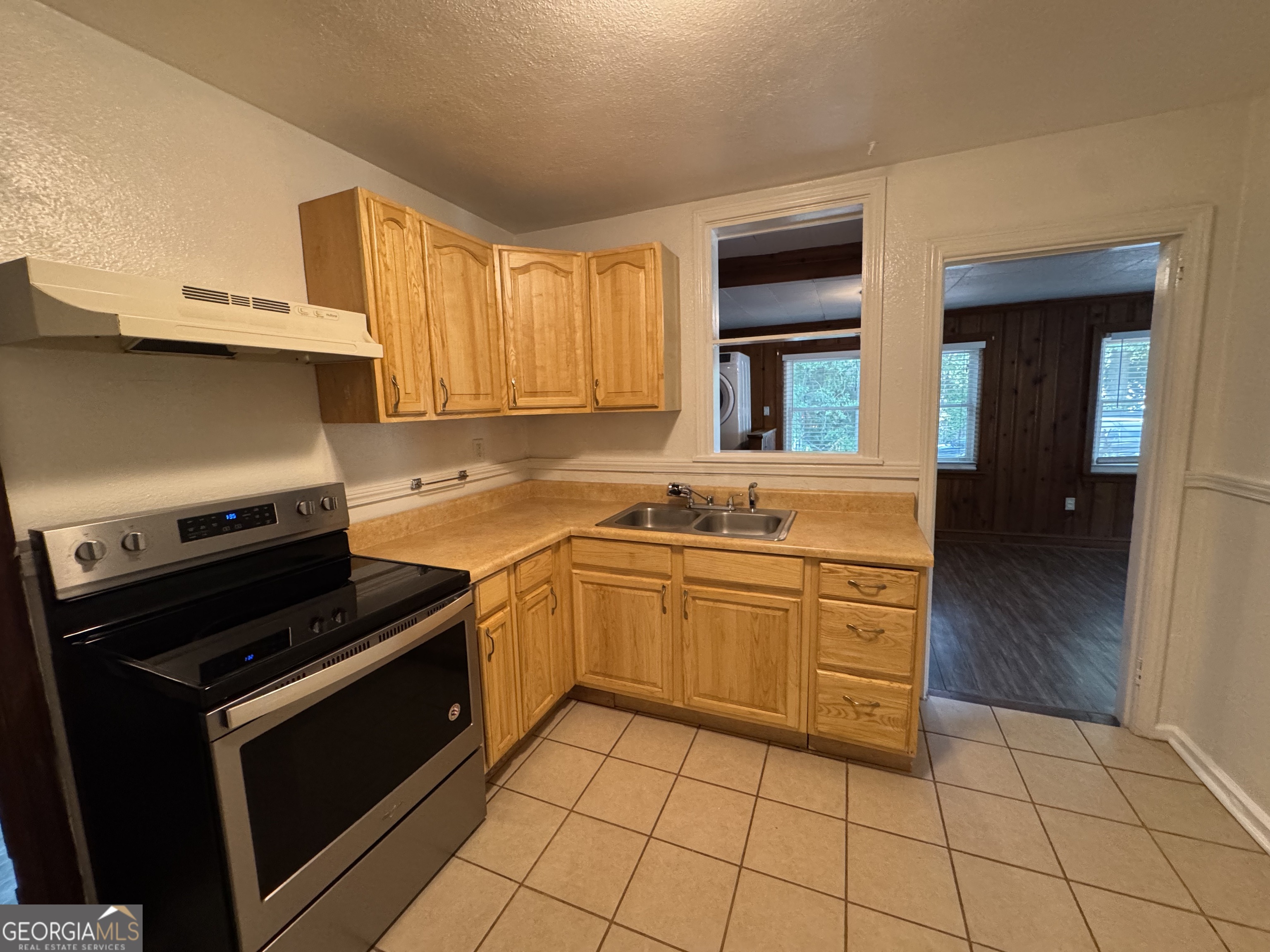 1980 South Lumpkin Street, Unit B Athens, GA 30606 - Photo 6 of 13 a kitchen with a stove a sink and a microwave