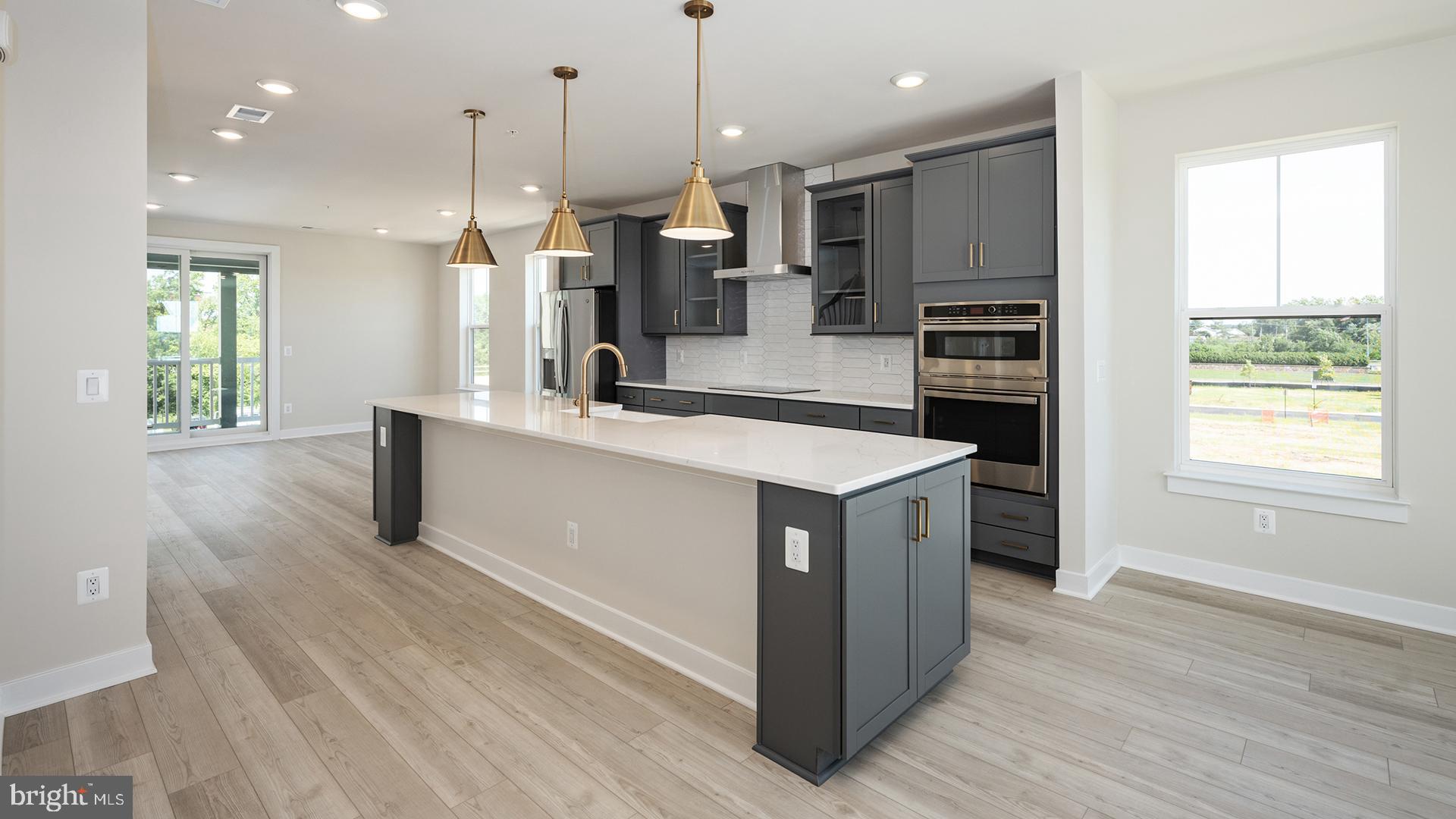 a kitchen with kitchen island a sink stainless steel appliances and window