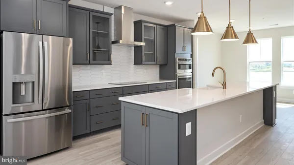a kitchen with granite countertop a refrigerator and a sink