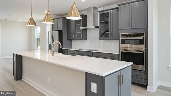 a kitchen with a refrigerator a sink and a stove