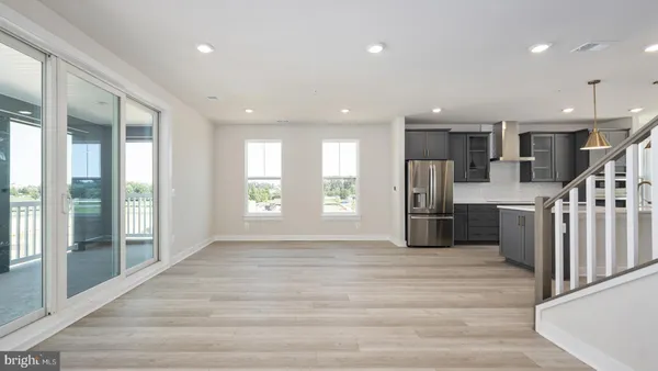 a open kitchen with stainless steel appliances kitchen island granite countertop a refrigerator and cabinets