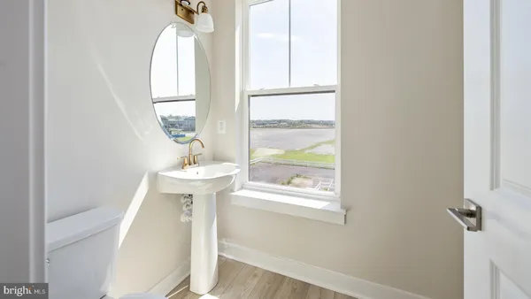 a bathroom with a sink a window and a mirror