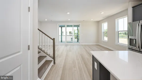 a view of a kitchen with furniture and staircase