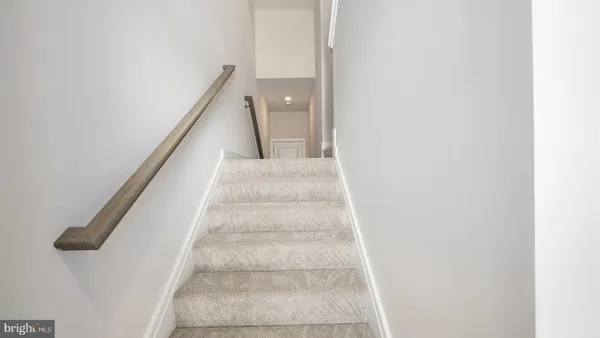 a view of staircase with white walls