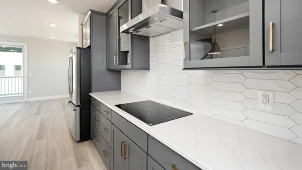 a kitchen with stainless steel appliances a refrigerator and a stove top oven
