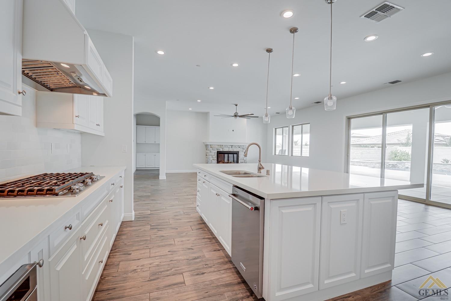 Undisclosed Address Bakersfield, CA 93311 - Photo 17 of 34 a large kitchen with stainless steel appliances kitchen island granite countertop a stove a sink and a refrigerator