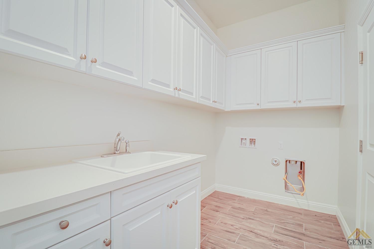 Undisclosed Address Bakersfield, CA 93311 - Photo 18 of 34 a bathroom with a sink and cabinets