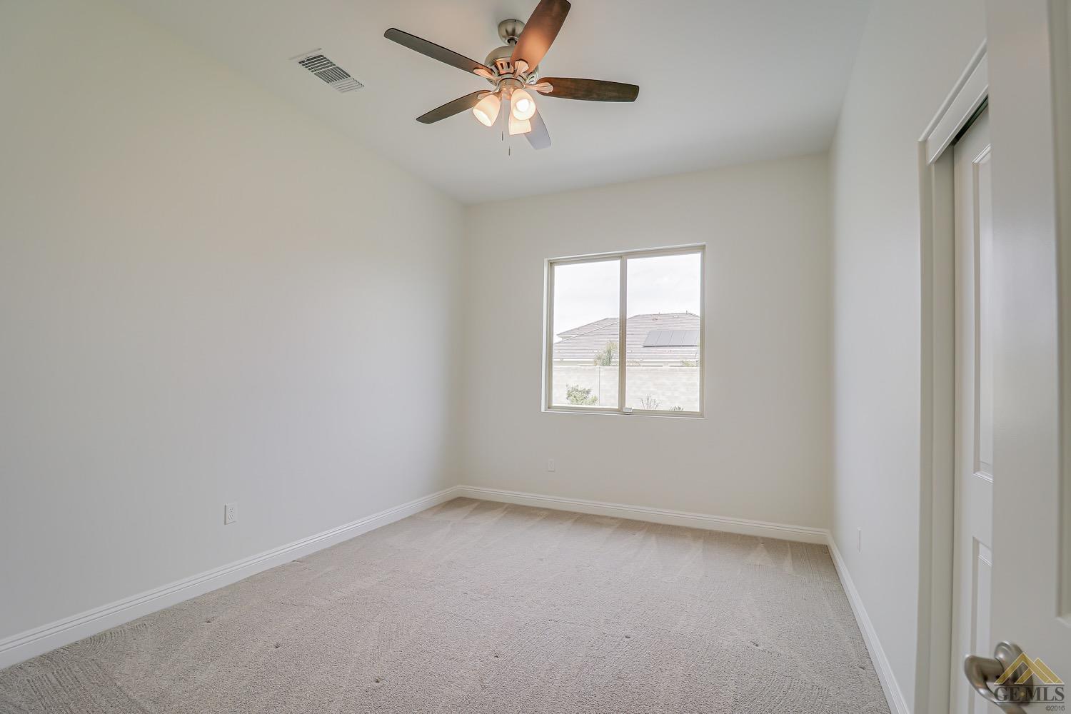 Undisclosed Address Bakersfield, CA 93311 - Photo 19 of 34 an empty room with a window and a fan